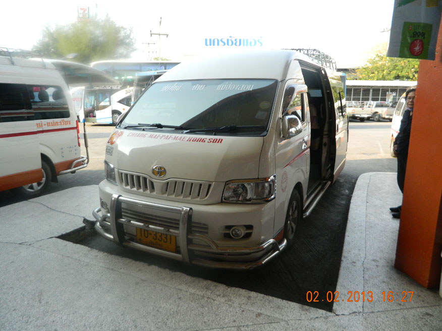 An orange and white 'roht too' (minivan) waits for a full compliment of passengers before heading to Pai. The journey takes 4 hours.